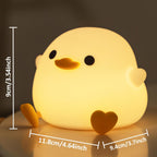 Yellow chick-shaped night light with measurements on a dark background