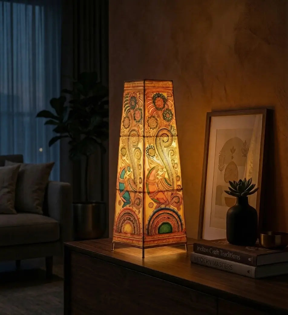 Decorative table lamp with intricate design on a wooden surface in a dimly lit room.